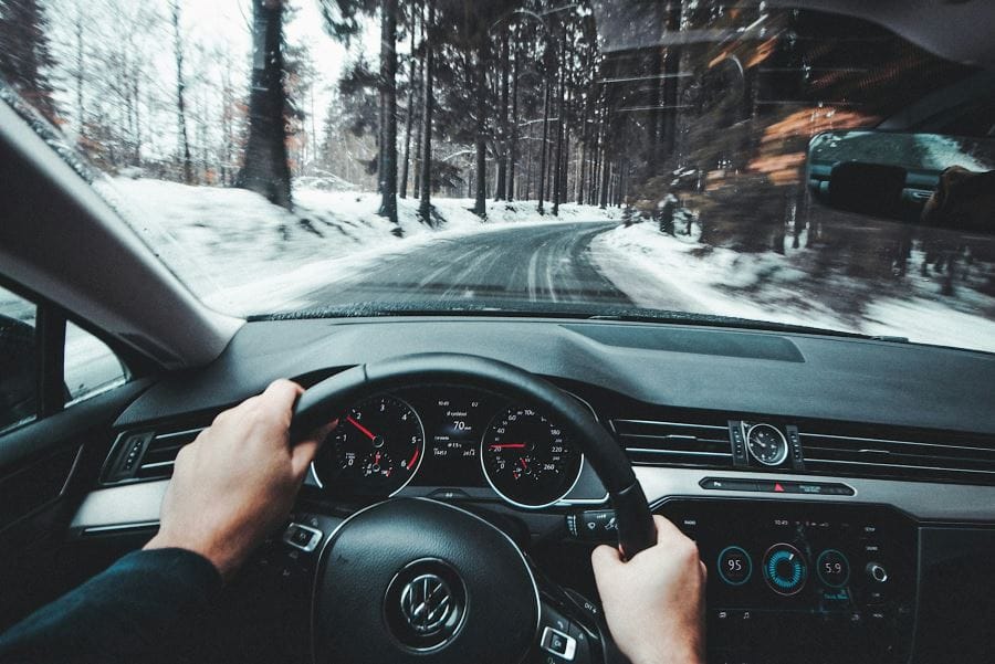 person driving Volkswagen vehicle through the snow